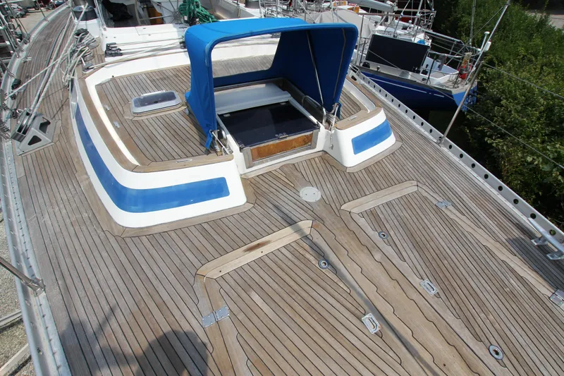 Slide: The Image of Deck of 1990 Nautor Swan 61 yacht with blue canopy and wooden finish. - 13