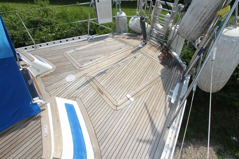 Slide: The Image of Teak deck of 1990 Nautor Swan 61 yacht, featuring clean lines and sturdy construction. - 14