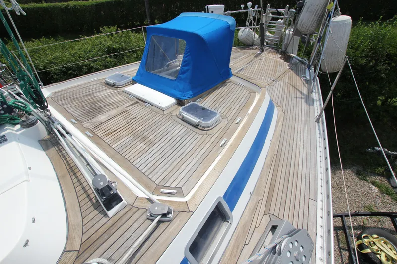 Slide: The Image of Deck of 1990 Nautor Swan 61 sailboat with blue canopy and wooden finish. - 15
