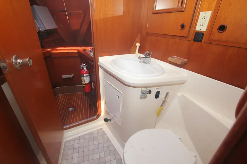 Slide: The Image of Bathroom interior of 1990 Nautor Swan 61 yacht with wooden cabinetry. - 21