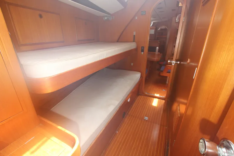 Slide: The Image of Interior of 1990 Nautor Swan 61 yacht with wooden bunk beds and cozy cabin design. - 22