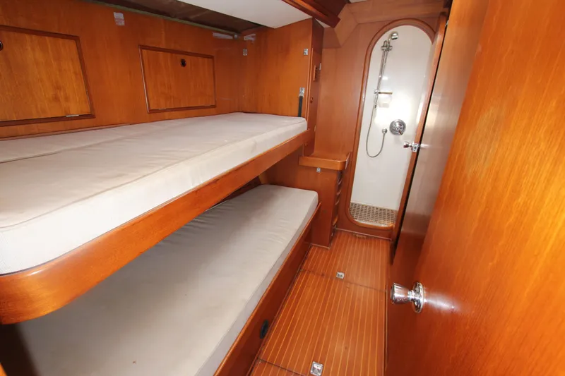 Slide: The Image of Interior of 1990 Nautor Swan 61 yacht with wooden bunk beds and shower. - 25