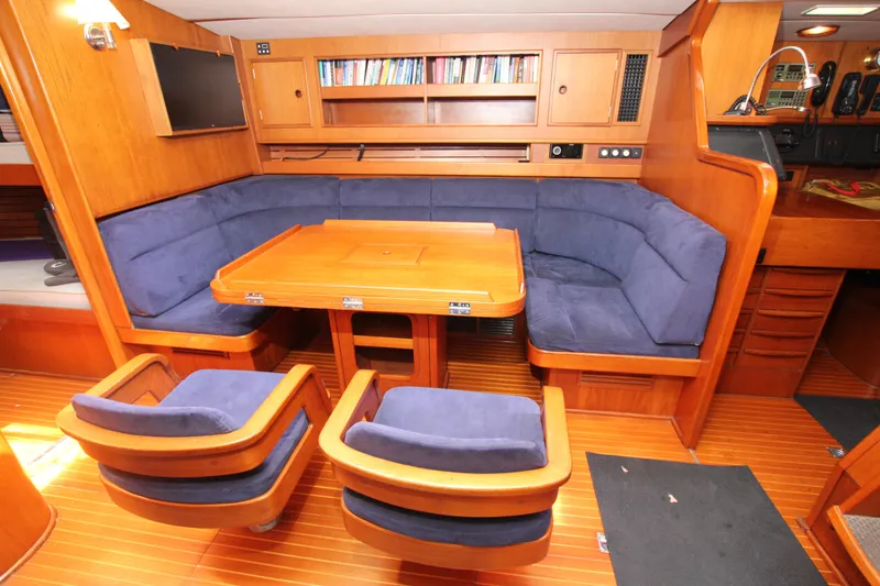 Slide: The Image of Luxurious interior of 1990 Nautor Swan 61 yacht with plush seating and wooden finishes. - 32