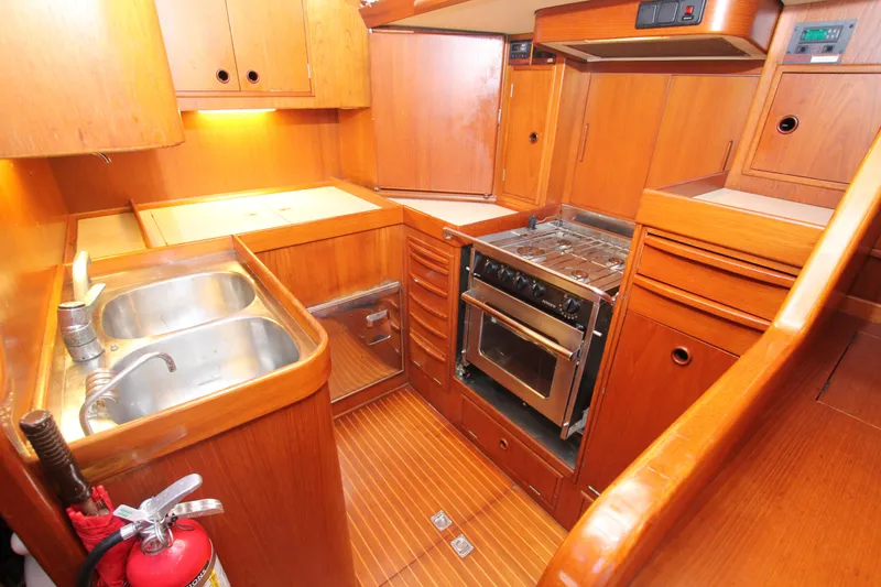 Slide: The Image of Galley kitchen in 1990 Nautor Swan 61 yacht with wooden cabinetry and stainless steel appliances. - 33