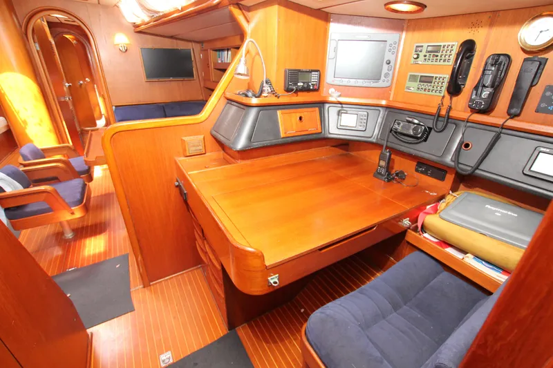 Slide: The Image of Interior of 1990 Nautor Swan 61 yacht with navigation station and wooden furnishings. - 35
