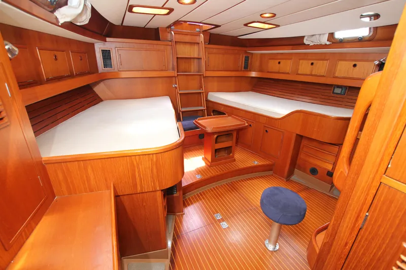 Slide: The Image of Luxurious 1990 Nautor Swan 61 yacht interior with wooden furnishings and cozy sleeping area. - 39