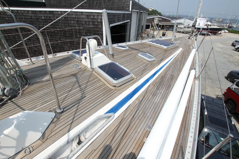 Slide: The Image of Deck view of 1990 Nautor Swan 61 yacht with wooden finish and hatches. - 4
