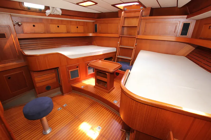 Slide: The Image of Luxurious 1990 Nautor Swan 61 yacht interior with wooden furnishings and cozy sleeping area. - 40