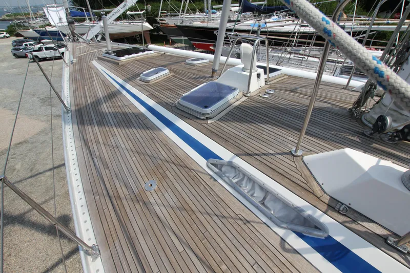 Slide: The Image of Deck view of 1990 Nautor Swan 61 yacht with teak finish and blue accents. - 5