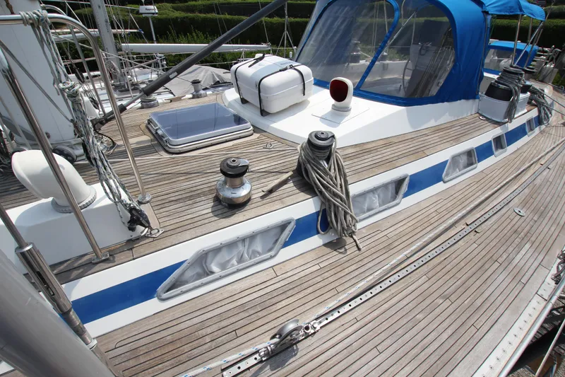 Slide: The Image of Deck of 1990 Nautor Swan 61 yacht with blue canopy and wooden finish. - 6