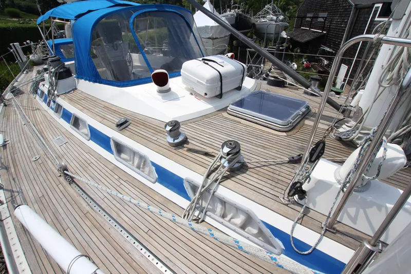 Slide: The Image of Deck of 1990 Nautor Swan 61 sailboat with blue canopy and wooden finish. - 7