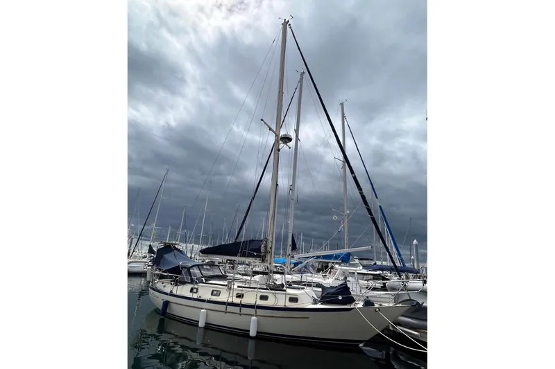 Slide: The Image of Sailboat Pacific Seacraft PSC 37, 1990 model, docked under cloudy skies. - 3