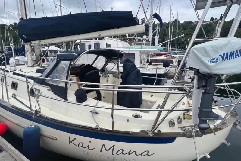 Slide: The Image of 1990 Pacific Seacraft PSC 37 sailboat docked, named "Kai Mana," in Seattle marina. - 5