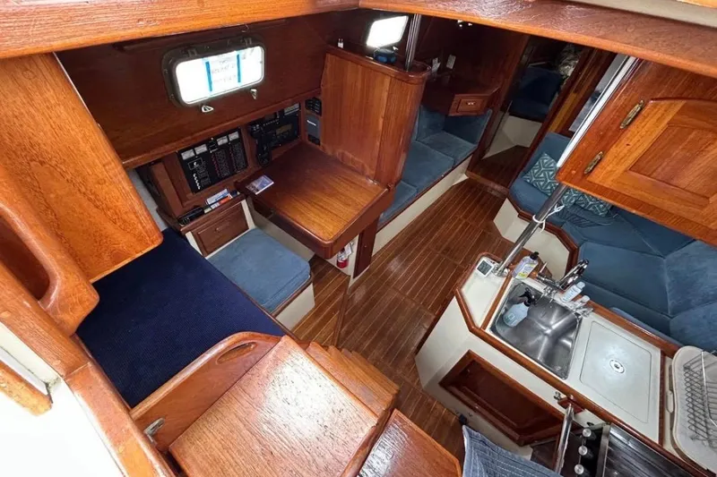 Slide: The Image of Interior of 1990 Pacific Seacraft PSC 37 sailboat with wood finish and compact kitchen. - 6