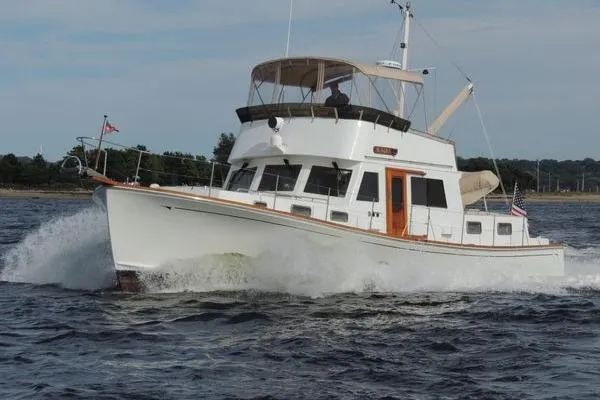 The Image of 1987 Jarvis Newman Lyman Morse 46' Flybridge Cruiser navigating through water. - 0