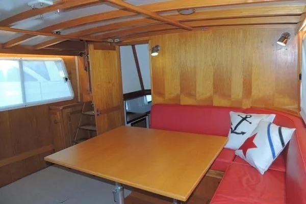 Slide: The Image of 1987 Jarvis Newman 46' Flybridge Cruiser interior with wooden paneling and red seating. - 16