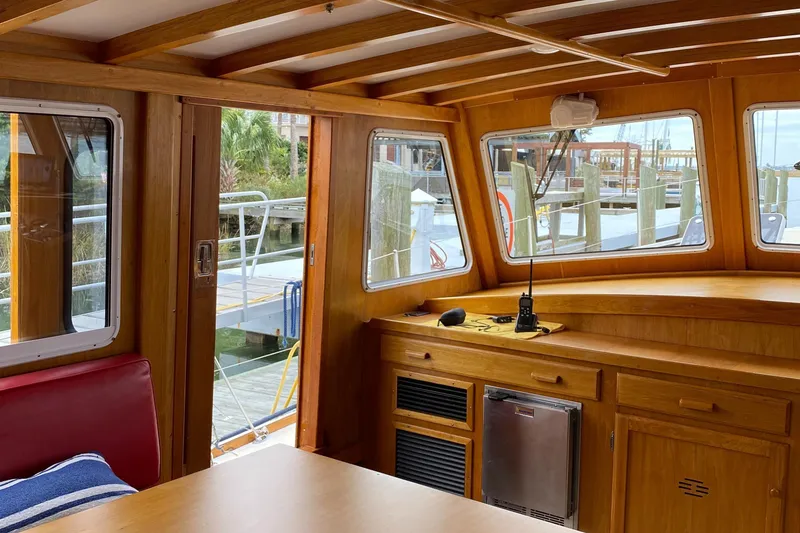 Slide: The Image of Interior of 1987 Jarvis Newman 46' Flybridge Cruiser with wooden finish and marina view. - 21
