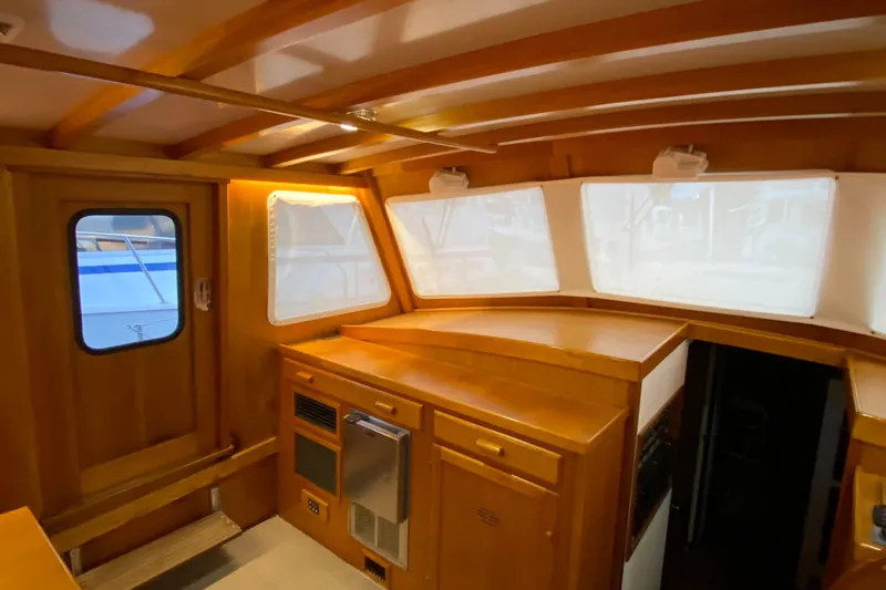 Slide: The Image of Interior of 1987 Jarvis Newman 46' Flybridge Cruiser with wooden cabinetry and windows. - 22