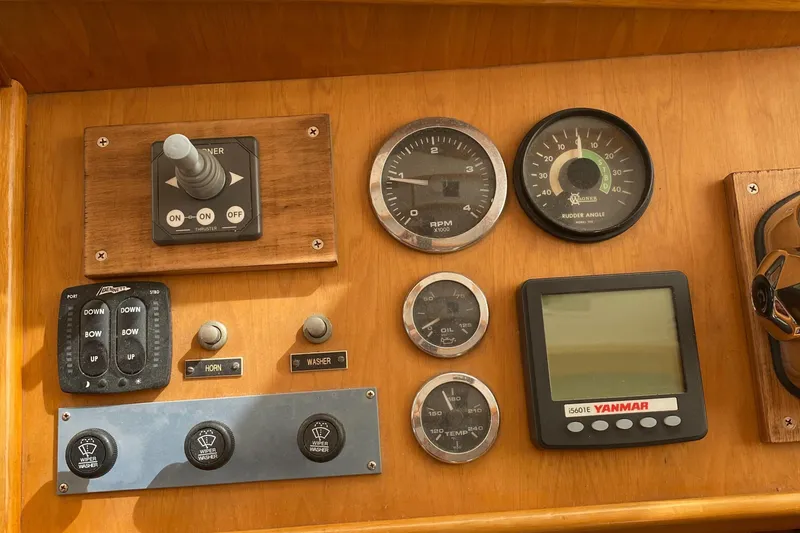 Slide: The Image of Control panel of a 1987 Jarvis Newman 46' Flybridge Cruiser with gauges and switches. - 26