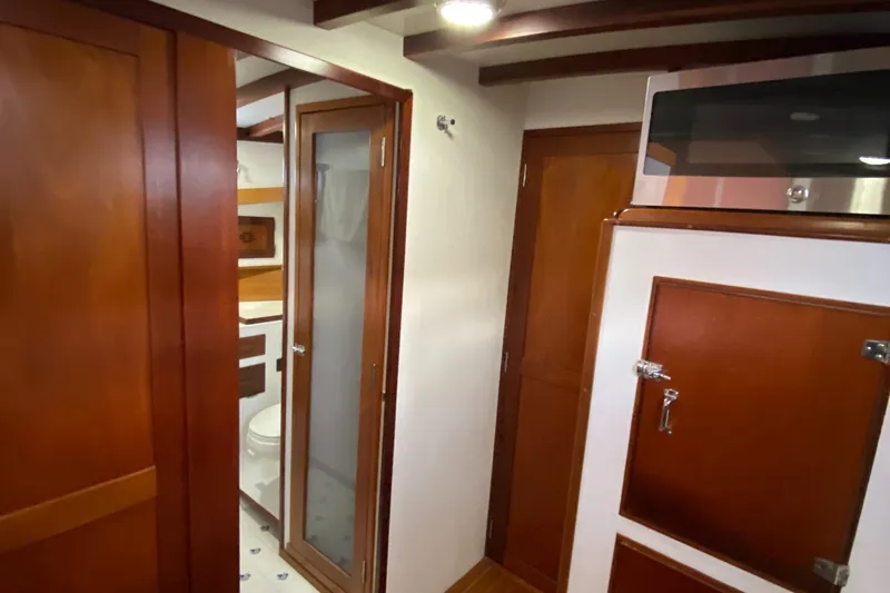 Slide: The Image of Interior of 1987 Jarvis Newman 46' Flybridge Cruiser with wooden cabinetry and bathroom. - 36
