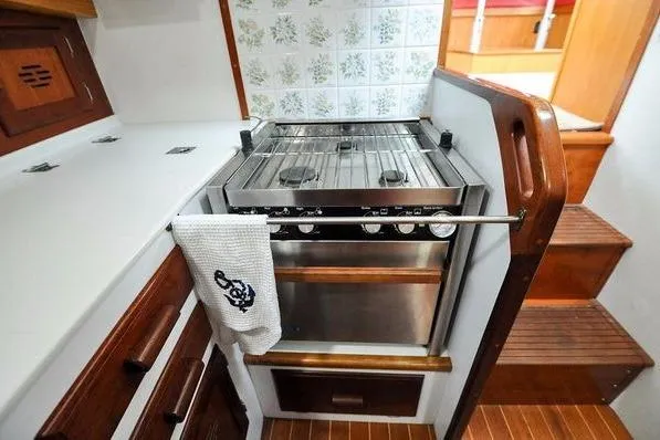 Slide: The Image of Galley kitchen in 1987 Jarvis Newman 46' Flybridge Cruiser with stove and wooden cabinetry. - 37