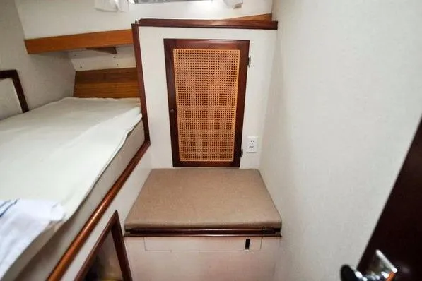 Slide: The Image of 1987 Jarvis Newman 46' Flybridge Cruiser cabin interior with bunk bed and storage. - 40