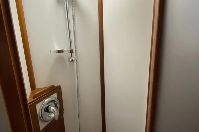 Slide: The Image of Shower area in 1987 Jarvis Newman 46' Flybridge Cruiser, featuring chrome fixtures and wood accents. - 41