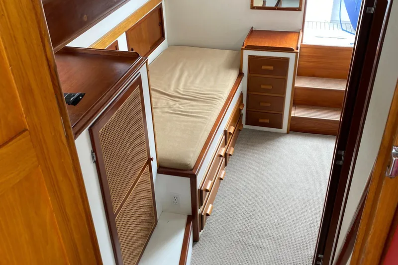 Slide: The Image of Interior of 1987 Jarvis Newman 46' Flybridge Cruiser with wooden cabinetry and bed. - 47