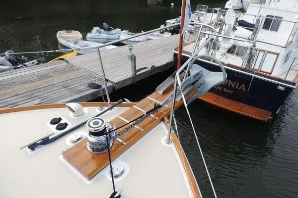 Slide: The Image of 1987 Jarvis Newman 46' Flybridge Cruiser docked with wooden deck and winch. - 5