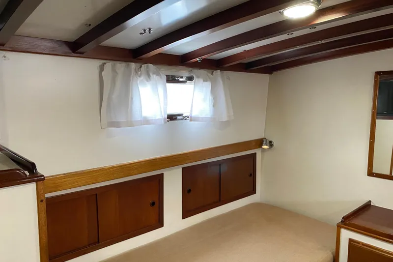 Slide: The Image of Interior cabin of 1987 Jarvis Newman 46' Flybridge Cruiser with wooden accents and window. - 53