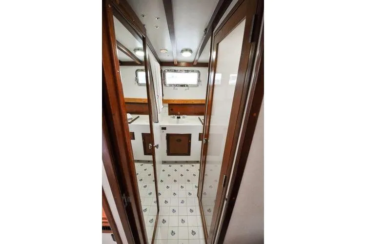 Slide: The Image of 1987 Jarvis Newman 46' Flybridge Cruiser interior with wood accents and tiled flooring. - 58