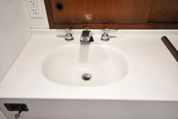 Slide: The Image of White sink with chrome faucets on a 1987 Jarvis Newman 46' Flybridge Cruiser. - 61