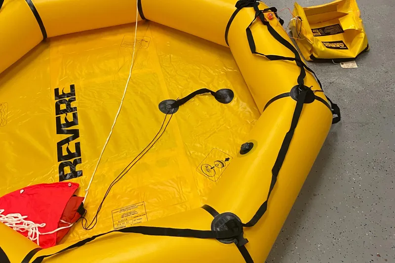 Slide: The Image of Yellow Revere life raft on gray floor, associated with 1988 Jarvis Newman 46' Flybridge Downeast. - 63