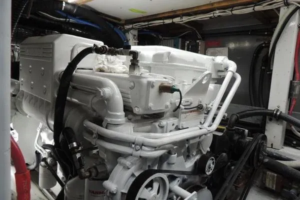 Slide: The Image of Engine room of 1987 Jarvis Newman 46' Flybridge Cruiser, showcasing a well-maintained marine engine. - 66