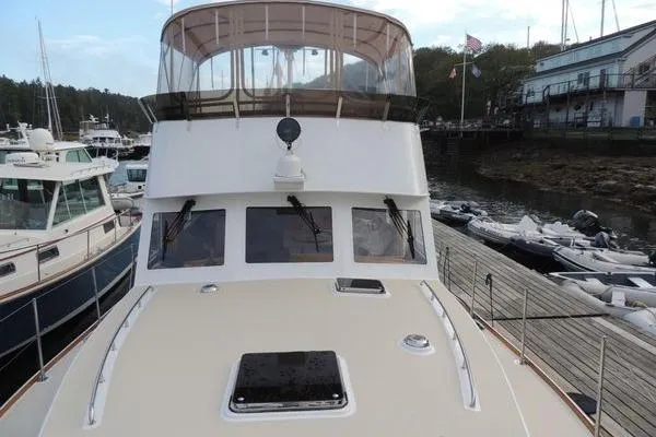 Slide: The Image of 1987 Jarvis Newman 46' Flybridge Cruiser docked at marina, front view. - 7