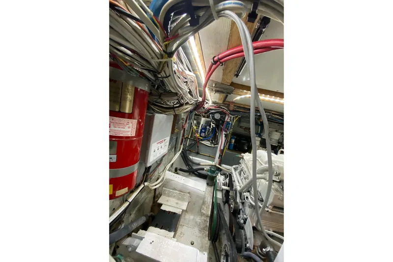 Slide: The Image of Engine room of 1987 Jarvis Newman 46' Flybridge Cruiser with wiring and machinery. - 70