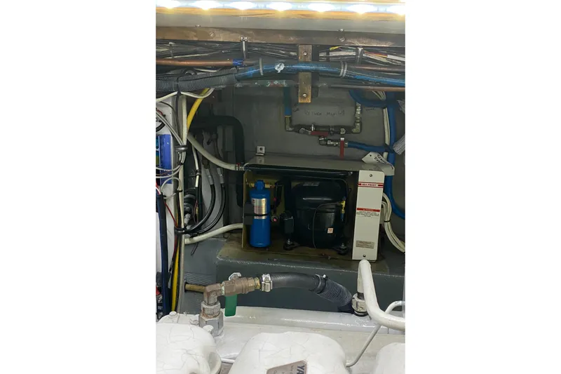 Slide: The Image of Engine room of 1987 Jarvis Newman 46' Flybridge Cruiser with visible wiring and components. - 73
