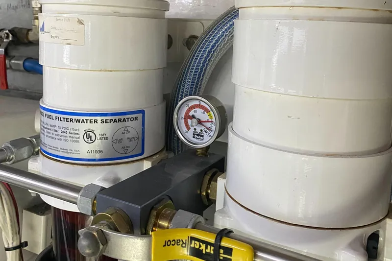 Slide: The Image of Engine room of 1987 Jarvis Newman 46' Flybridge Cruiser with fuel filter and gauge. - 75