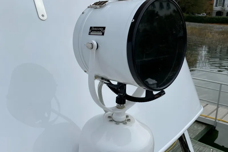 Slide: The Image of 1988 Jarvis Newman 46' Flybridge Downeast spotlight detail, docked by water. - 8