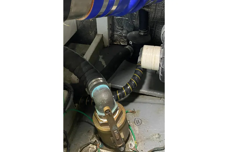 Slide: The Image of Engine room of 1987 Jarvis Newman 46' Flybridge Cruiser, showing hoses and fittings. - 80