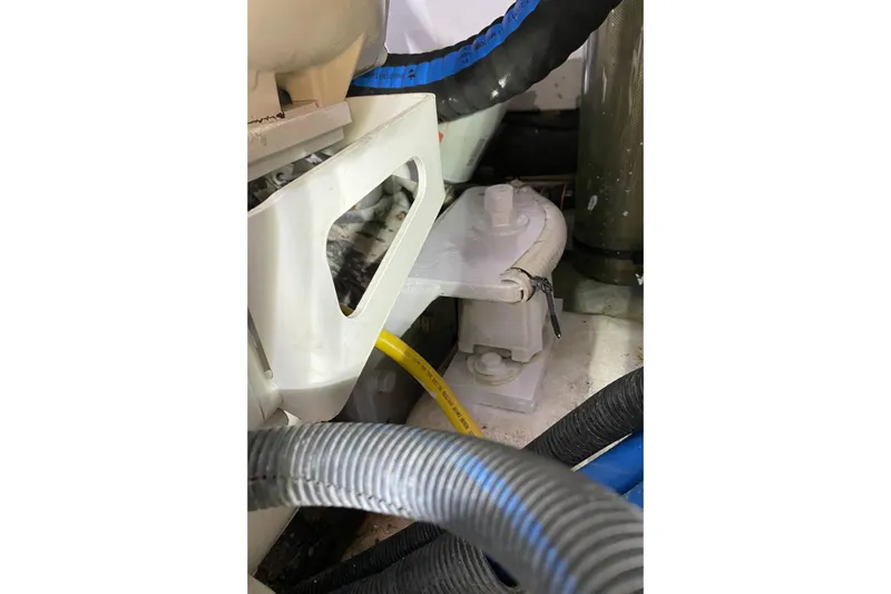 Slide: The Image of Engine compartment of 1987 Jarvis Newman 46' Flybridge Cruiser with hoses and components. - 83