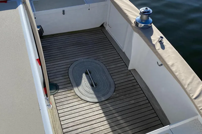 Slide: The Image of 1987 Jarvis Newman 46' Flybridge Cruiser deck with wooden flooring and winch. - 9