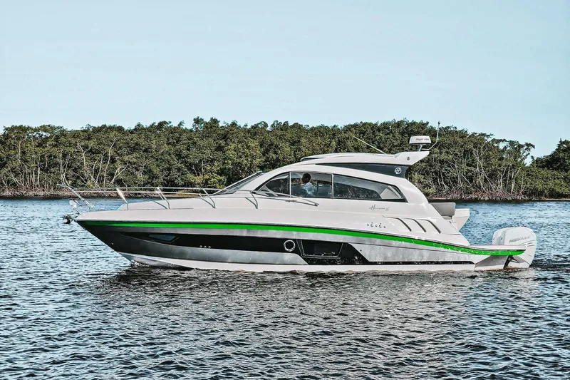 The Image of 2026 Hanover 375 yacht cruising on a serene waterway with lush greenery in the background. - 1