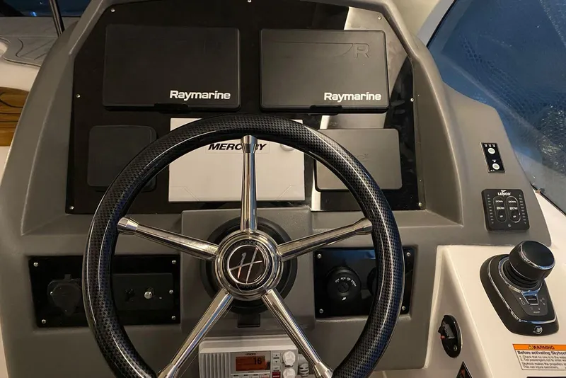 Slide: The Image of Steering wheel and dashboard of 2026 Hanover 375 boat with Raymarine electronics. - 16