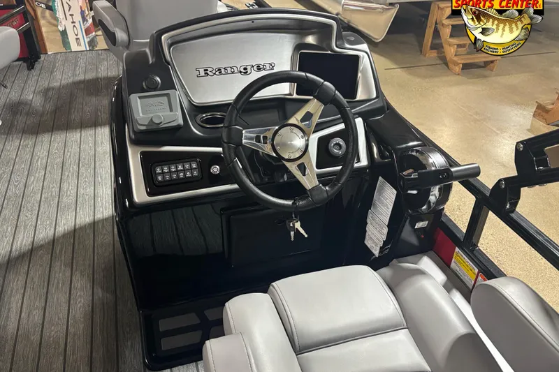Slide: The Image of 2026 Ranger Reata 220F boat dashboard with steering wheel and controls. - 7