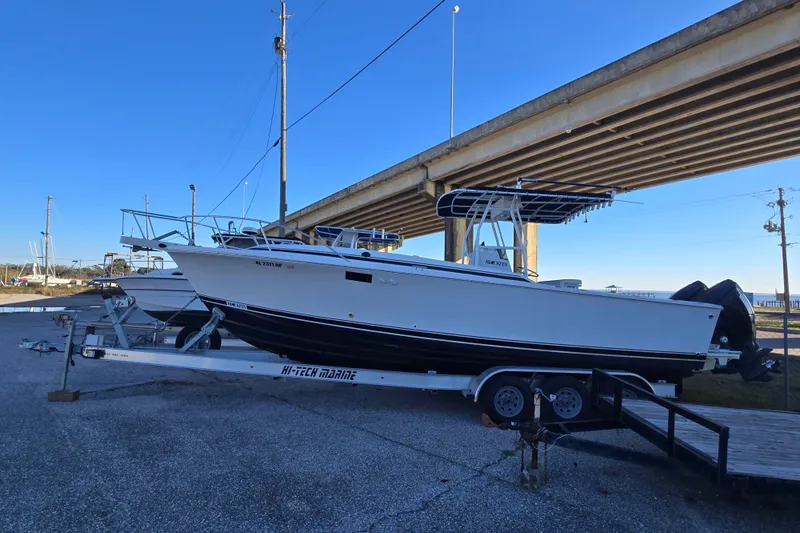 Slide: The Image of 1989 Blackfin 272 CC boat on trailer under bridge. - 1