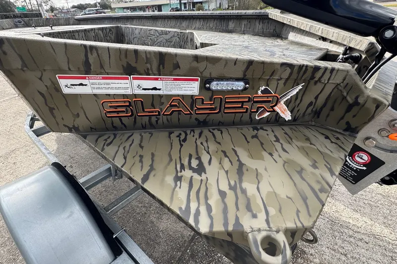 Slide: The Image of 2026 SeaArk 1752 Slayer X Pro boat with camouflage design and safety warnings. - 11