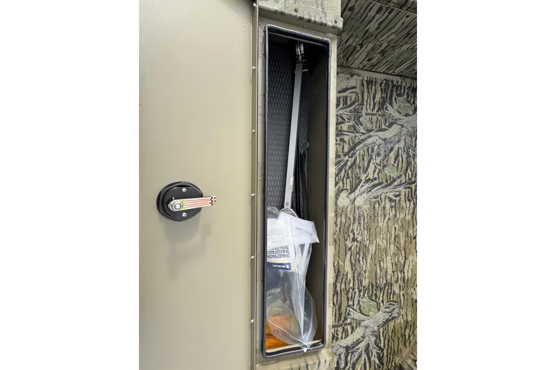 Slide: The Image of Storage compartment in 2026 SeaArk 1752 Slayer X Pro boat, featuring camo interior design. - 12