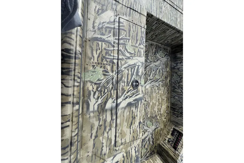 Slide: The Image of Camouflage interior of 2026 SeaArk 1752 Slayer X Pro boat, featuring detailed woodland design. - 13