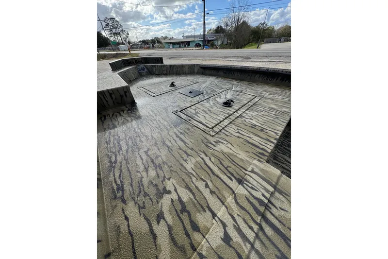 Slide: The Image of 2026 SeaArk 1752 Slayer X Pro boat interior with camouflage pattern and storage compartments. - 14